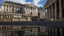 A puddle reflects the Bank of England (BOE) in the City of London, U.K., on Tuesday, Aug. 4, 2020. Bank of England officials could signal on Thursday that the case for more monetary stimulus is growing as a nascent rebound from the pandemic-induced recession risks fading. Photographer: Simon Dawson/Bloomberg via Getty Images