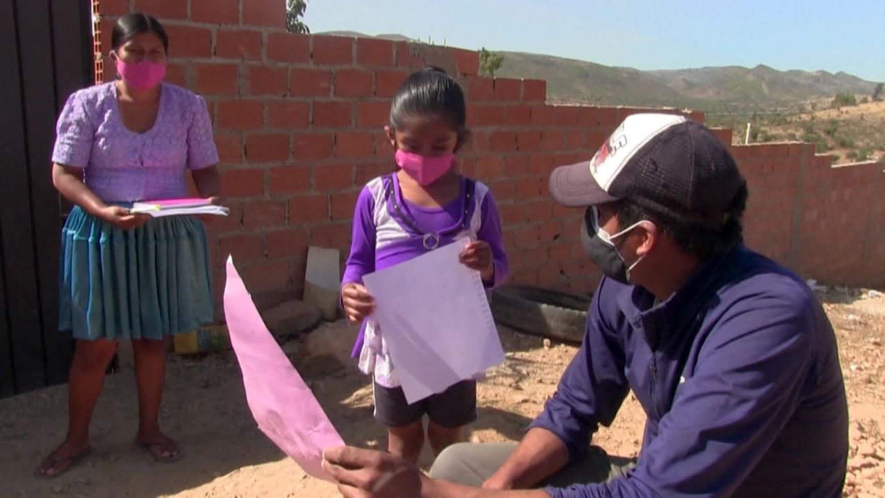 A teacher in rural Bolivia with a student amid the coronavirus pandemic.