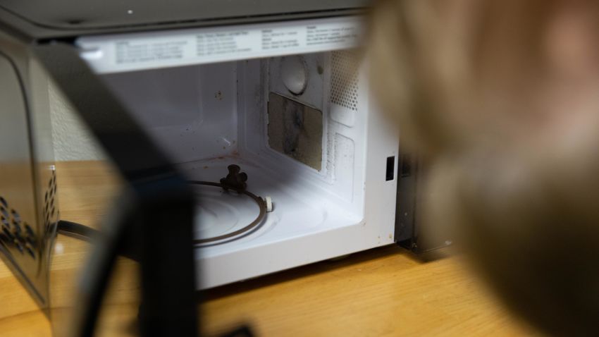 Dr. Michael Pecht of the University of Maryland's Center for Advanced Life Cycle Engineering looks at an AmazonBasics microwave from a customer who said it caught on fire.