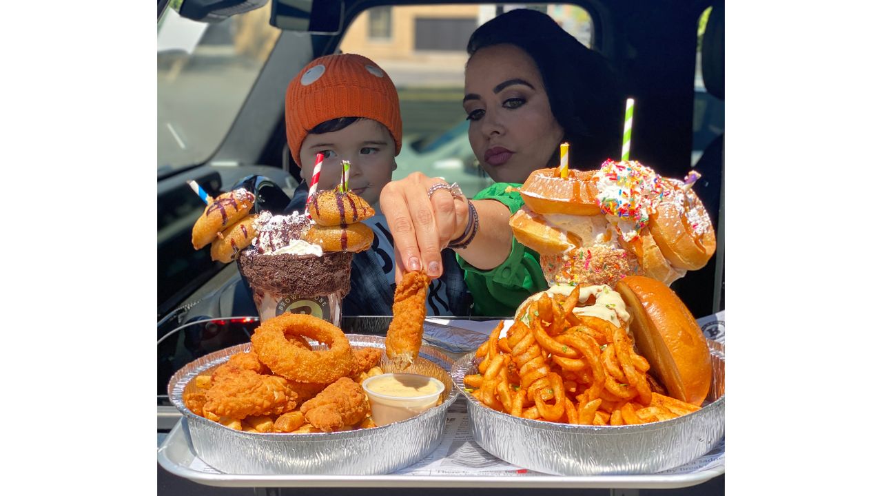 A mother and son enjoy over-the-top carhop dining at Brownstone Pancake Factory in Edgewater, New Jersey.