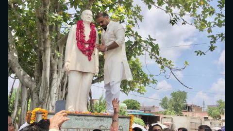 Dushyant Singh pictured next to a statue of his grandfather, Raja Man Singh.