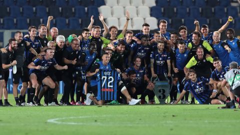 Atalanta players and staff celebrate with a Josep Ilicic shirt after the team's last game of the season.
