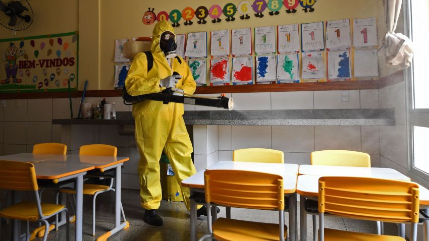 A Federal District's employee disinfects a public school as a measure against the spread of the new coronavirus in Brasilia, on August 5, 2020. - The local government has begun preparations for the safe reopening of schools in early September, as restrictions related to the COVID-19 lockdown are eased. (Photo by EVARISTO SA / AFP) (Photo by EVARISTO SA/AFP via Getty Images)