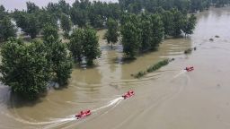 This aerial photo shows firefighters patroling with boats at a flooded area near the Yangtze river in Zhenjiang, in China's eastern Jiangsu province on July 20. 