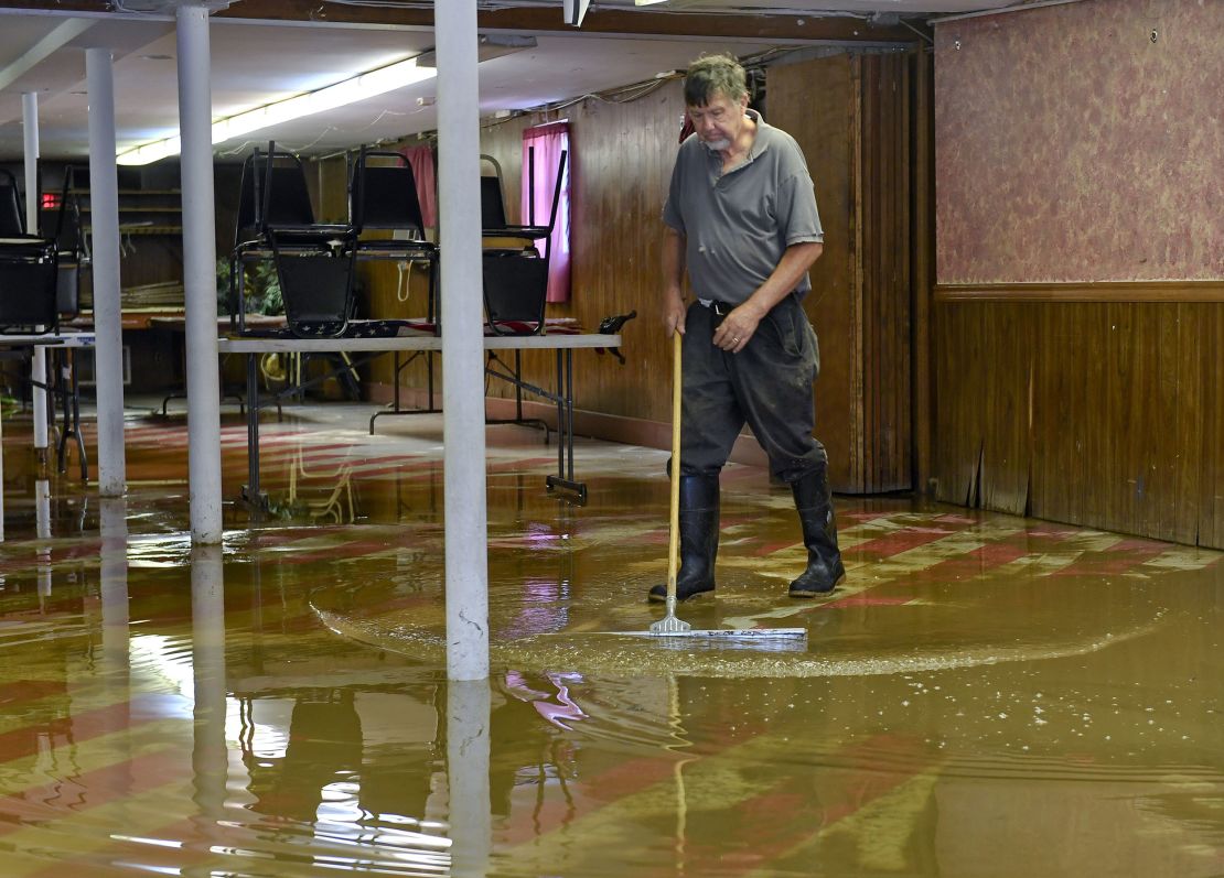 Ken Wegman, the owner of Wegman's Restaurant on Pottsville Pike in Muhlenberg, Pennsylvania, works on clearing water out of the ground floor of the building