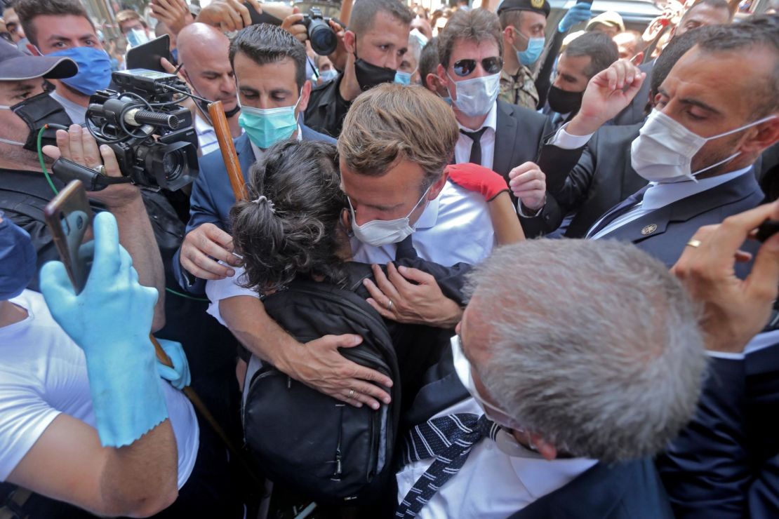 A Lebanese youth hugs Macron during  his visit to Gemmayzeh.