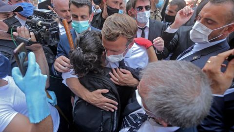 A Lebanese youth hugs Macron during  his visit to Gemmayzeh.
