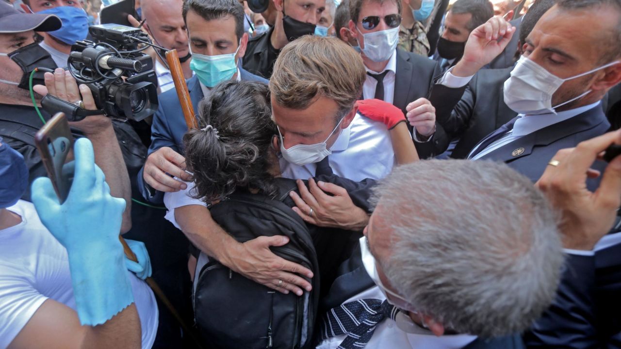 A Lebanese youth hugs Macron during  his visit to Gemmayzeh.