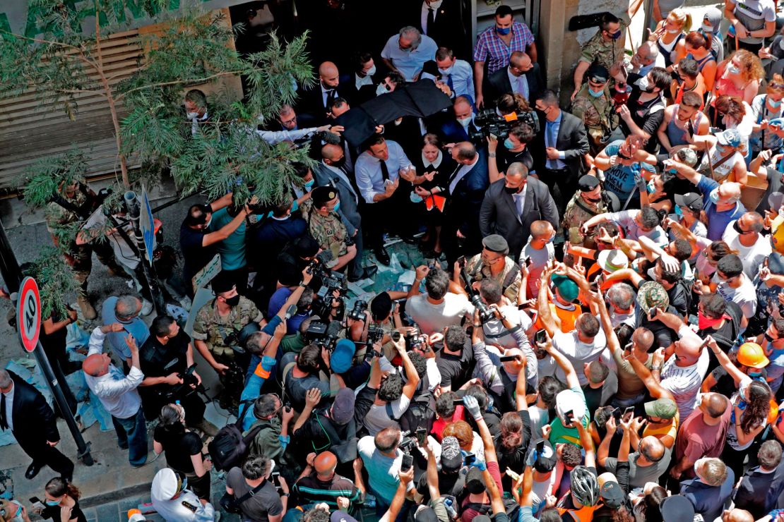 French President Emmanuel Macron speaks to the crowd in Beirut's Gemmayzeh neighborhood, which suffered extensive damage in Tuesday's massive explosion.