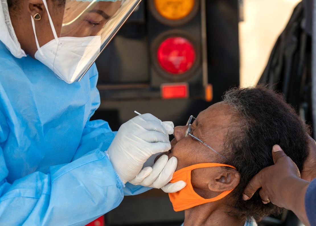 A heatlh worker collects a sample for testing in Johannesburg.