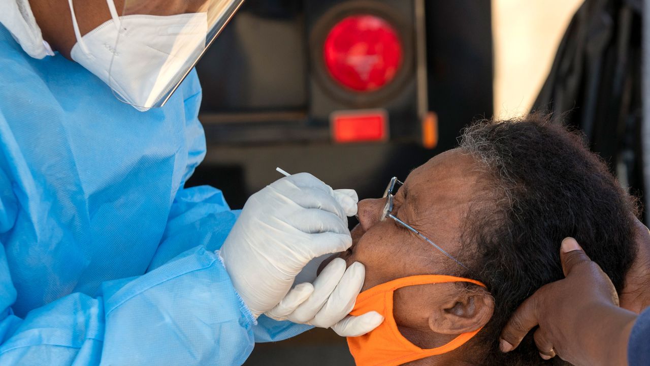 A heatlh worker collects a sample for testing in Johannesburg.