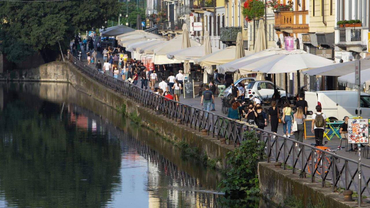 Milan in May. People in Italy are going out for dinner at restaurants, and enjoying the summer tradition of an aperitivo at a local square or bar.