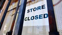 A "store closed" sign is posted on a store in Los Angeles, July 16, 2020.