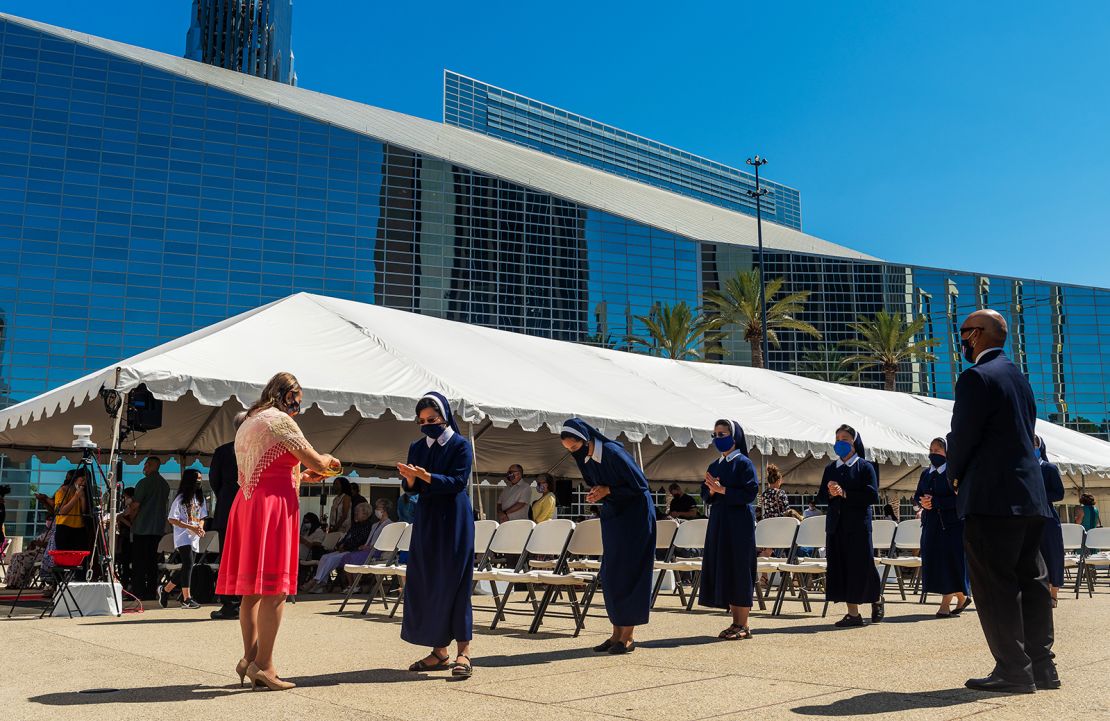 Sisters line up for communion during outdoor mass at Christ Cathedral in Garden Grove, California, on Sunday, July 19, 2020. 