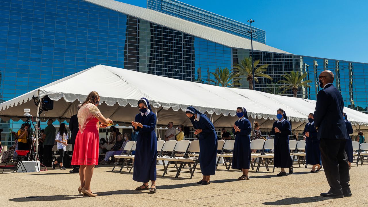 Sisters line up for communion during outdoor mass at Christ Cathedral in Garden Grove, California, on Sunday, July 19, 2020. 
