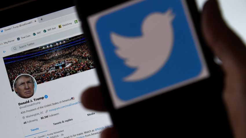 In this photo illustration, a Twitter logo is displayed on a mobile phone with President Trump's Twitter page shown in the background on May 27, 2020, in Arlington, Virginia. - US President Donald Trump threatened Wednesday to shutter social media platforms after Twitter for the first time acted against his false tweets, prompting the enraged Republican to double down on unsubstantiated claims and conspiracy theories. Twitter tagged two of Trump's tweets in which he claimed that more mail-in voting would lead to what he called a "Rigged Election" this November. (Photo by Olivier DOULIERY / AFP) (Photo by OLIVIER DOULIERY/AFP via Getty Images)