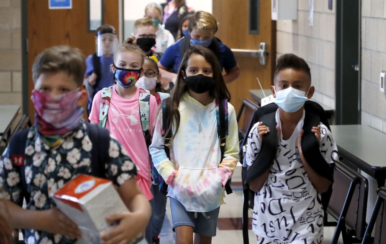 Elementary school students walk to class in Godley, Texas, on August 5. Three rural school districts in Johnson County were among the first in the state to head back to school for in-person classes.