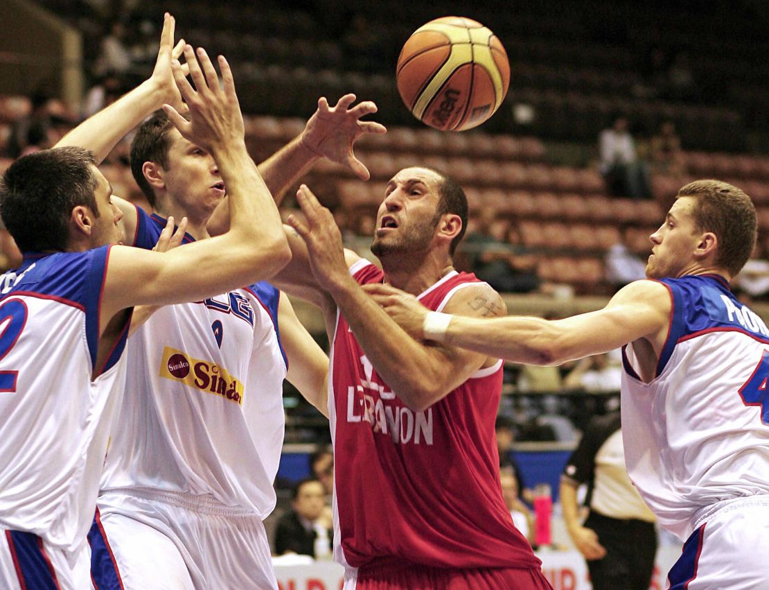 Lebanon's Fadi El Khatib (C) is blocked by Serbia and Montenegro's Goran Nikolic (L), Mile Ilic (2nd L) and Bojan Popovic (far R) as he goes to the basket during their Group A preliminary round match on the third day of the World Basketball Championship in Sendai, in Miyagi Prefecture, 21 August 2006.