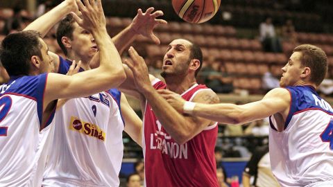Lebanon's Fadi El Khatib (C) is blocked by Serbia and Montenegro's Goran Nikolic (L), Mile Ilic (2nd L) and Bojan Popovic (far R) as he goes to the basket during their Group A preliminary round match on the third day of the World Basketball Championship in Sendai, in Miyagi Prefecture, 21 August 2006.