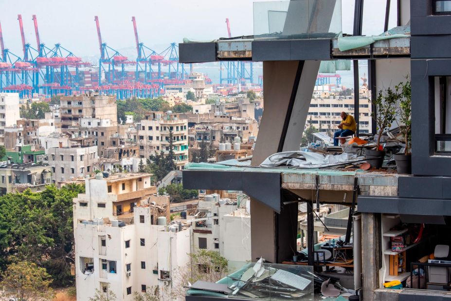 A man sits inside a damaged home in Beirut on August 7, 2020.