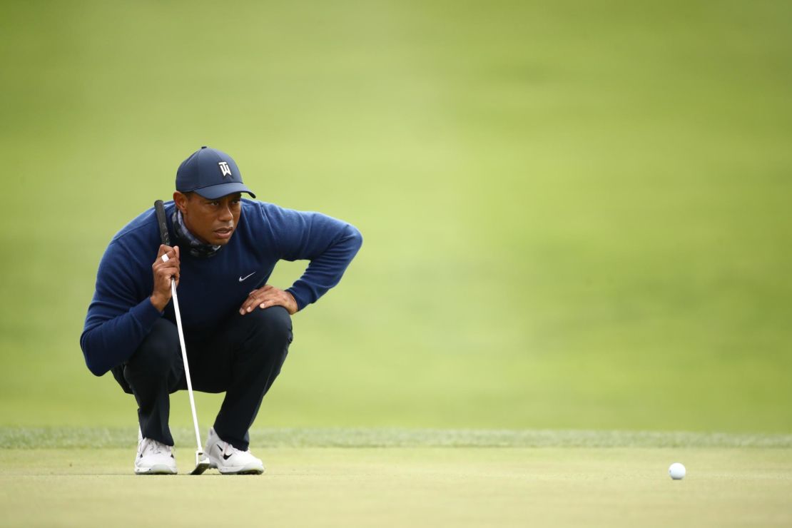 Woods lines up a putt on the 13th green.
