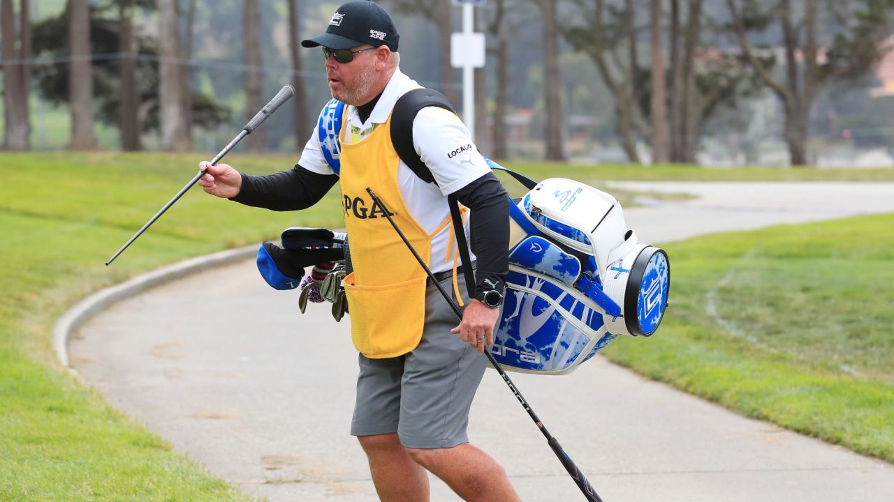 DeChambeau's caddie Tim Tucker carries the US golfer's new driver shaft.