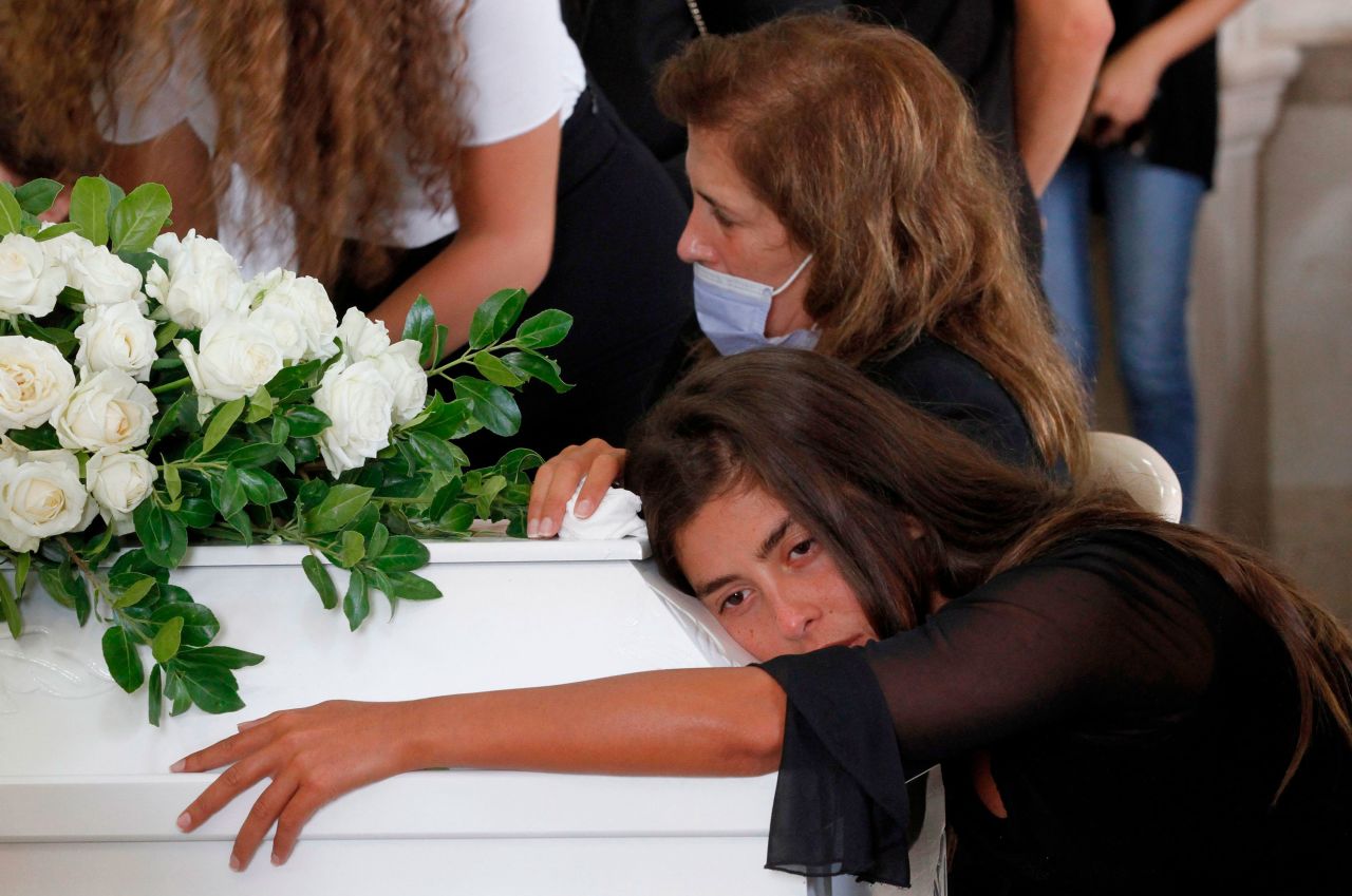 Christelle Helou hugs the coffin of her cousin Nicole in Sarba, Lebanon, on August 6, 2020.
