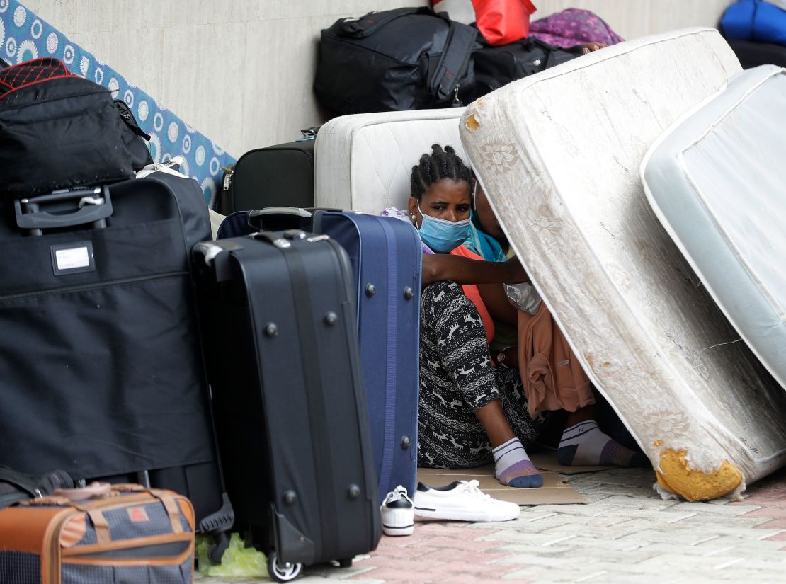 Ethiopian domestic workers who were dismissed by their employers gather with their belongings outside their country's embassy in Hazmiyeh, east of Beirut, on June 24, 2020. 