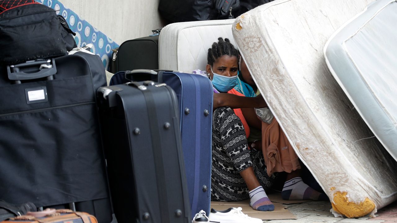 Ethiopian domestic workers who were dismissed by their employers gather with their belongings outside their country's embassy in Hazmiyeh, east of Beirut, on June 24, 2020.