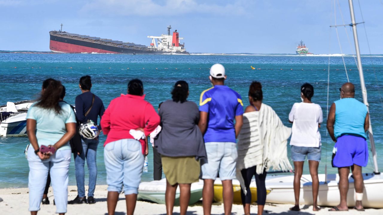 Bystanders look on near Blue Bay Marine Park on August 6.