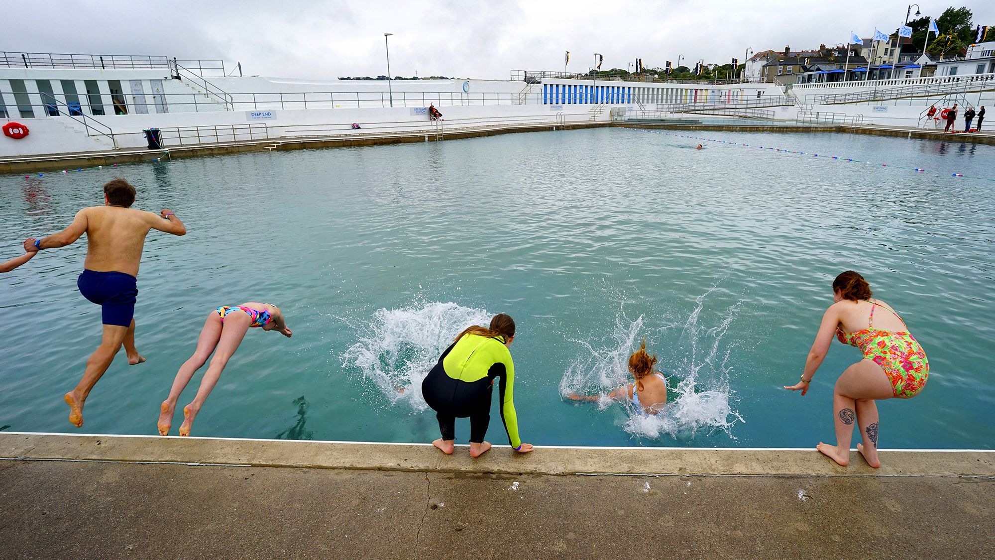 People swim at Jubilee Pool, an open-air seawater pool, after it reopened in Penzance, England, on July 25.