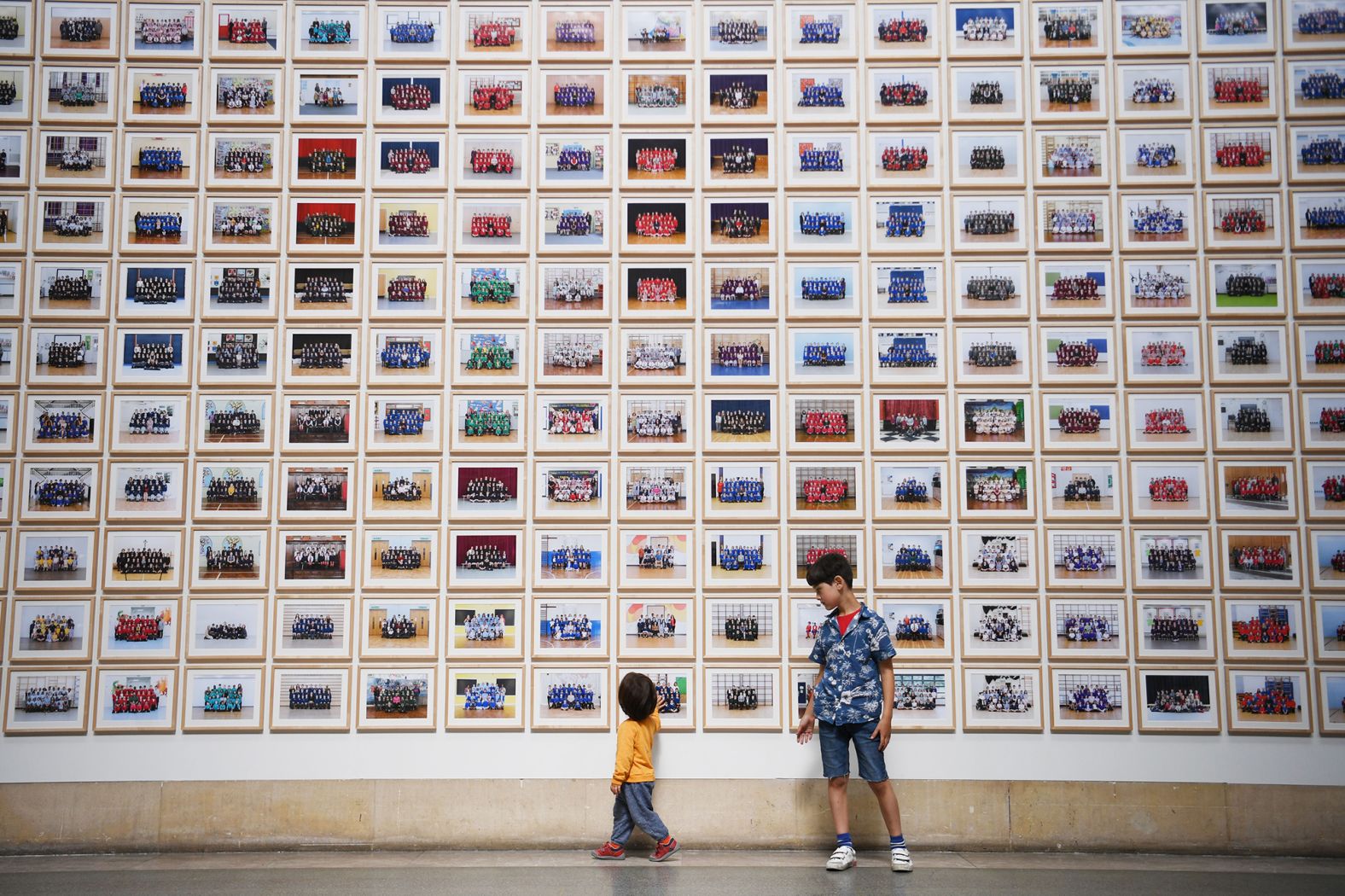 Children pose by Steve McQueen's "Year 3" shortly before the Tate Britain gallery reopened in London in late July.