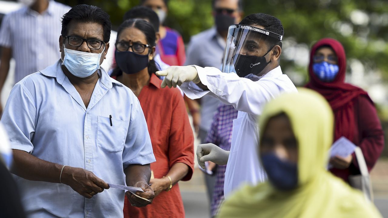 Sri Lankan voters cast their ballots with masks and face shields as parliamentary elections went on during the coronavirus pandemic. 
