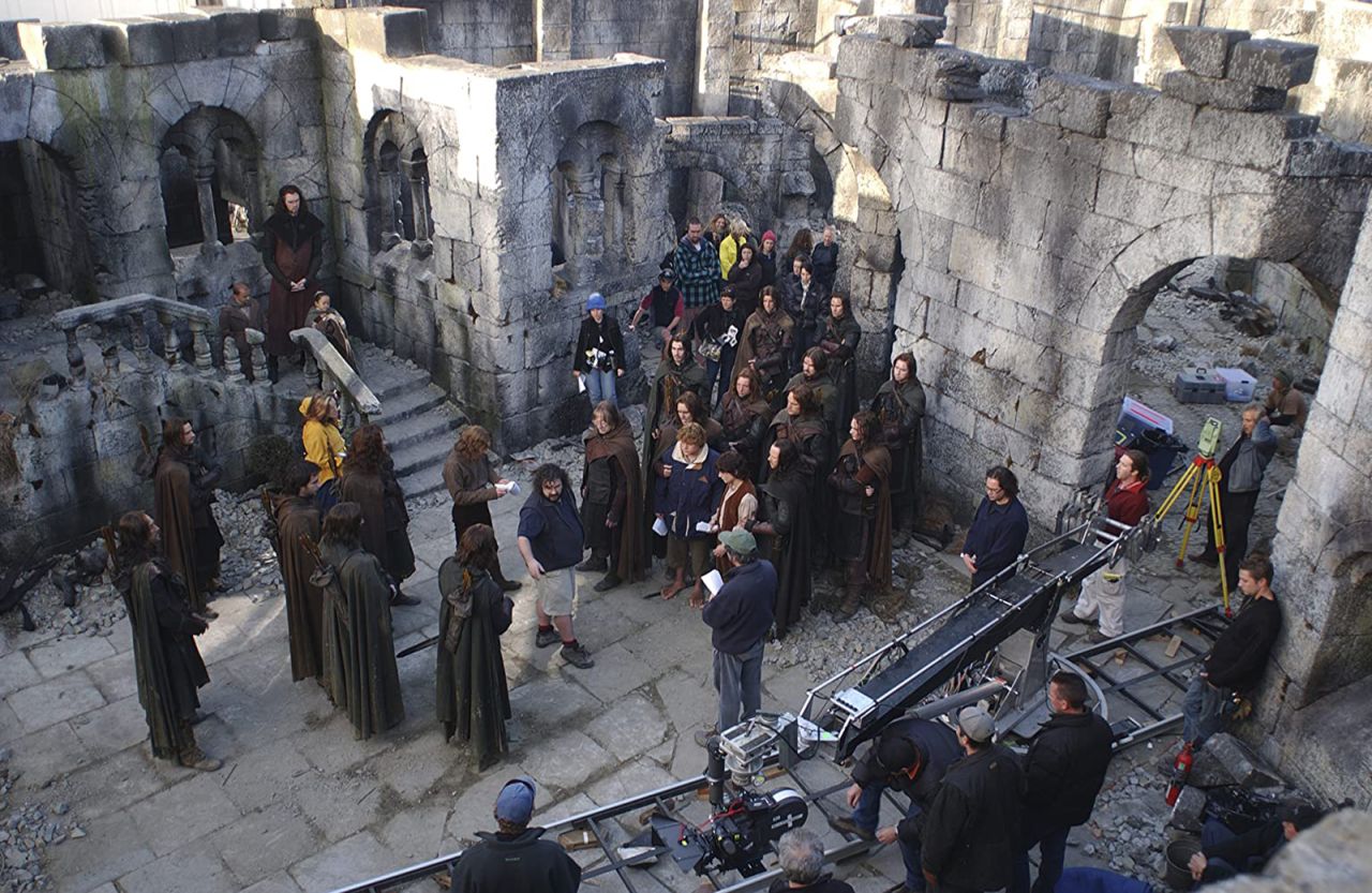 Shah (top left) on the set of "The Lord of the Rings," among the cast and crew receiving direction from Peter Jackson (center).