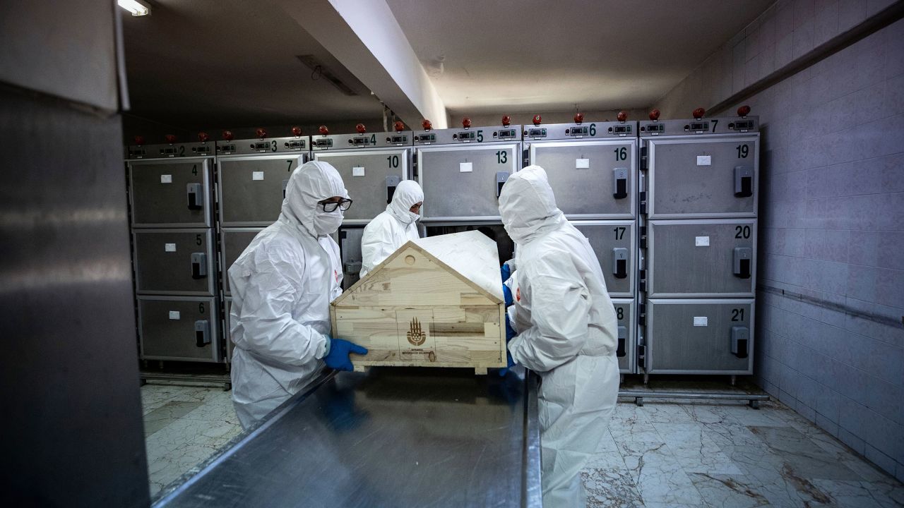 Officials with protective suits carry a coffin of a coronavirus victim before the process of ghusl, washing and shrouding the body, ahead of a Muslim funeral ceremony in Istanbul, Turkey, on May 10, 2020. 
