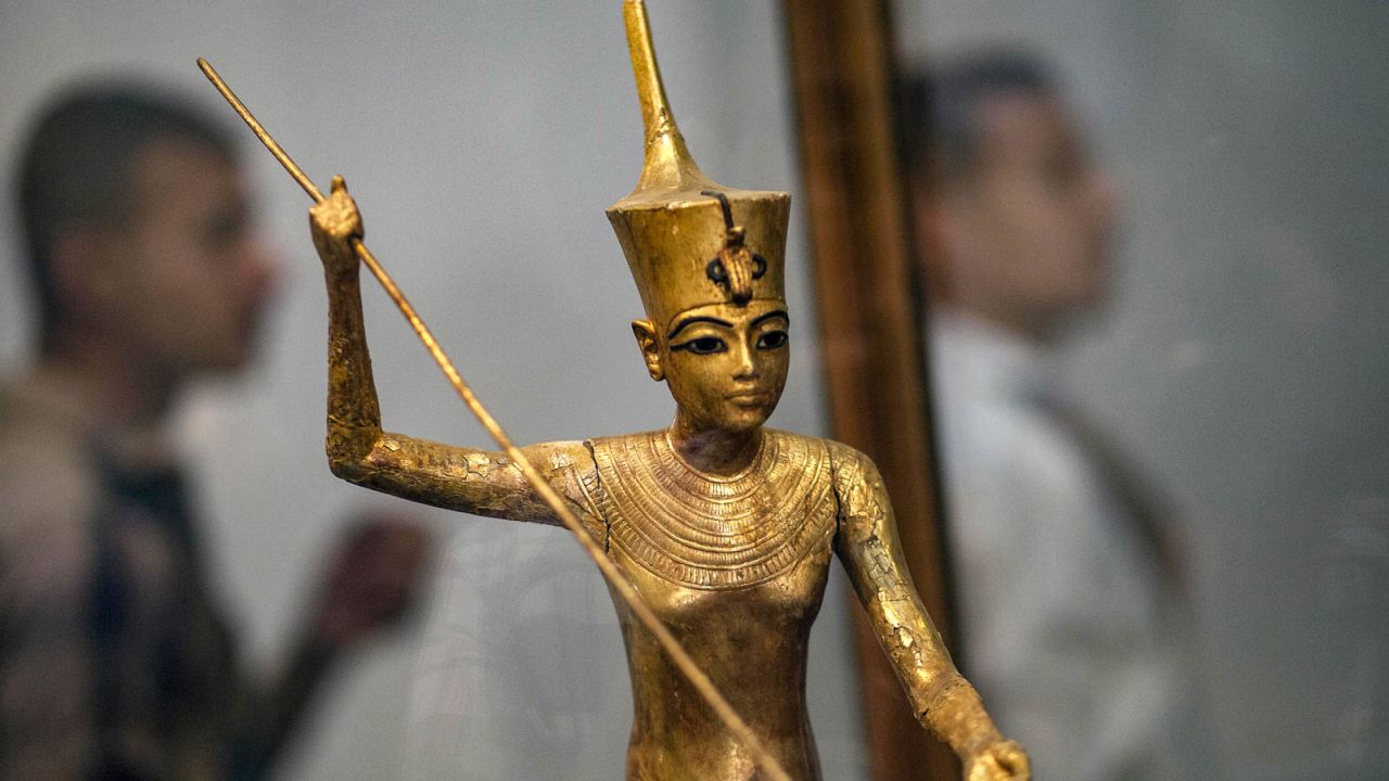 A golden statue of Tutankhamun is seen carrying a harpoon.