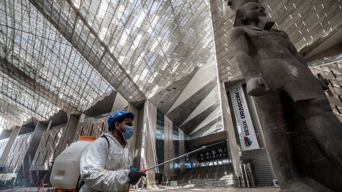 Workers spray the new museum's interior with disinfectant to combat Covid-19.