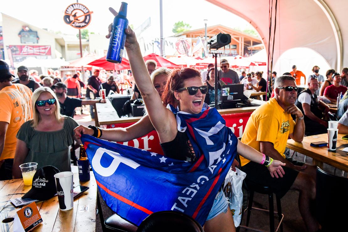 A woman wearing a Trump flag dances while watching a band perform at the 80th Sturgis Motorcycle Rally on Friday in Sturgis, South Dakota.