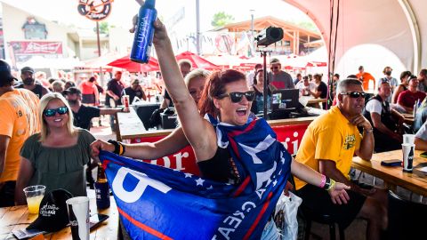 A woman wearing a Trump flag dances while watching a band perform at the 80th  Sturgis Motorcycle Rally on Friday in Sturgis, South Dakota. 