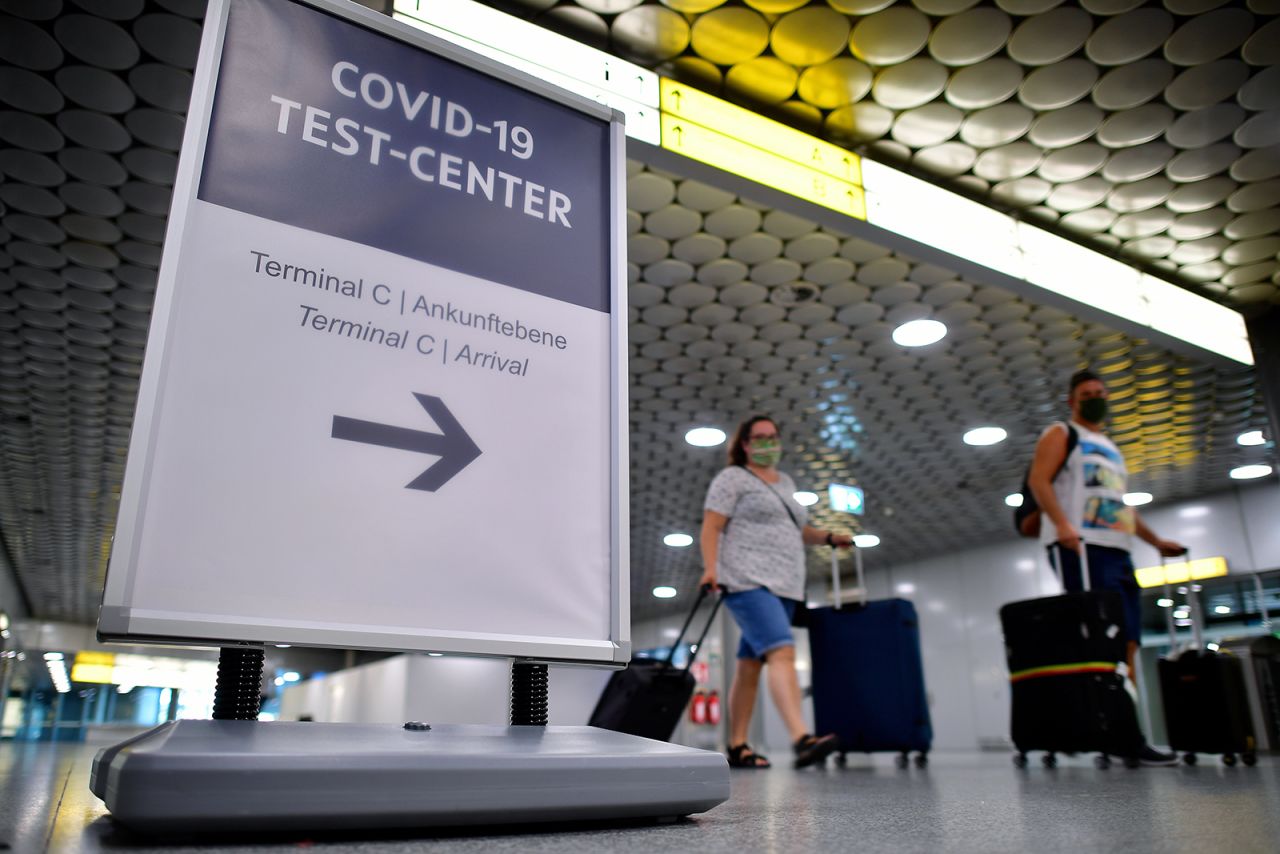 Travelers arriving from abroad wait to be tested for Covid-19 at an airport near Hanover, Germany, on August 8. The German government was requiring people arriving from high-risk designated nations to take a Covid-19 test.