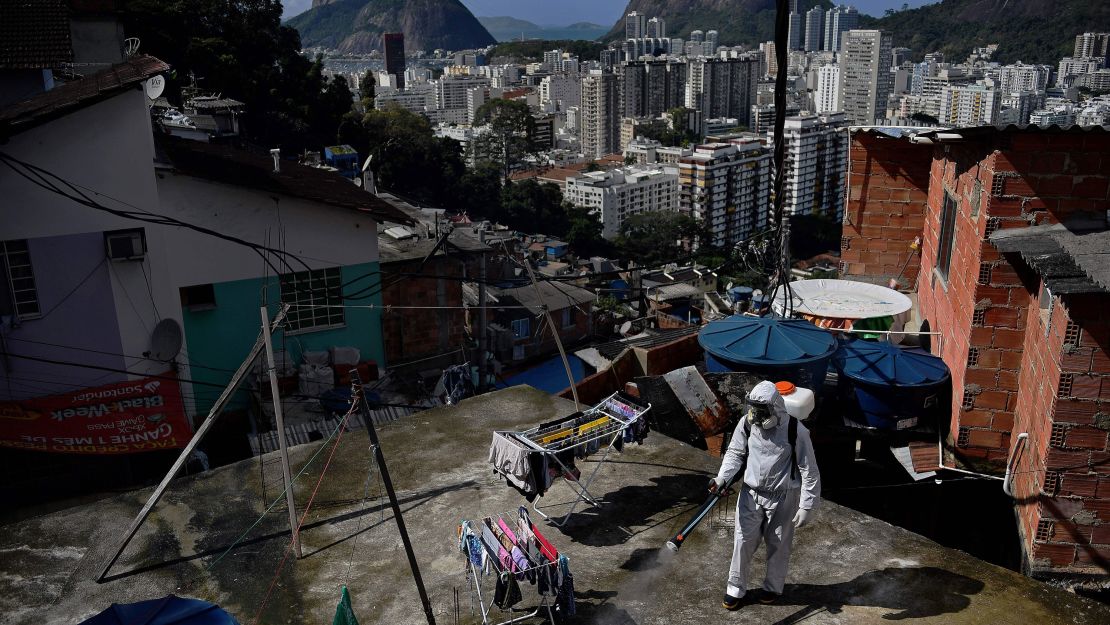 A volunteer disinfects a rooftop inside Santa Marta favela, in Rio de Janeiro on August 1.