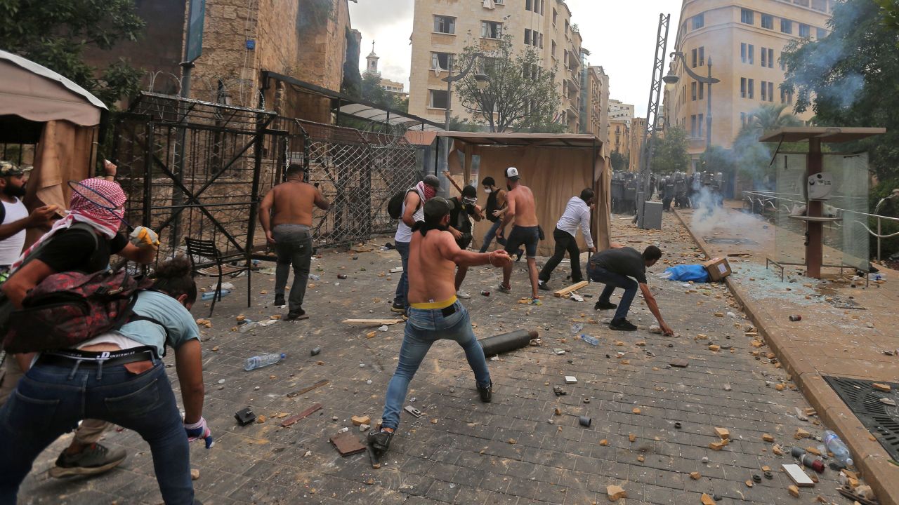 Protesters hurl rocks towards security forces during clashes in downtown Beirut, Lebanon, on Saturday.
