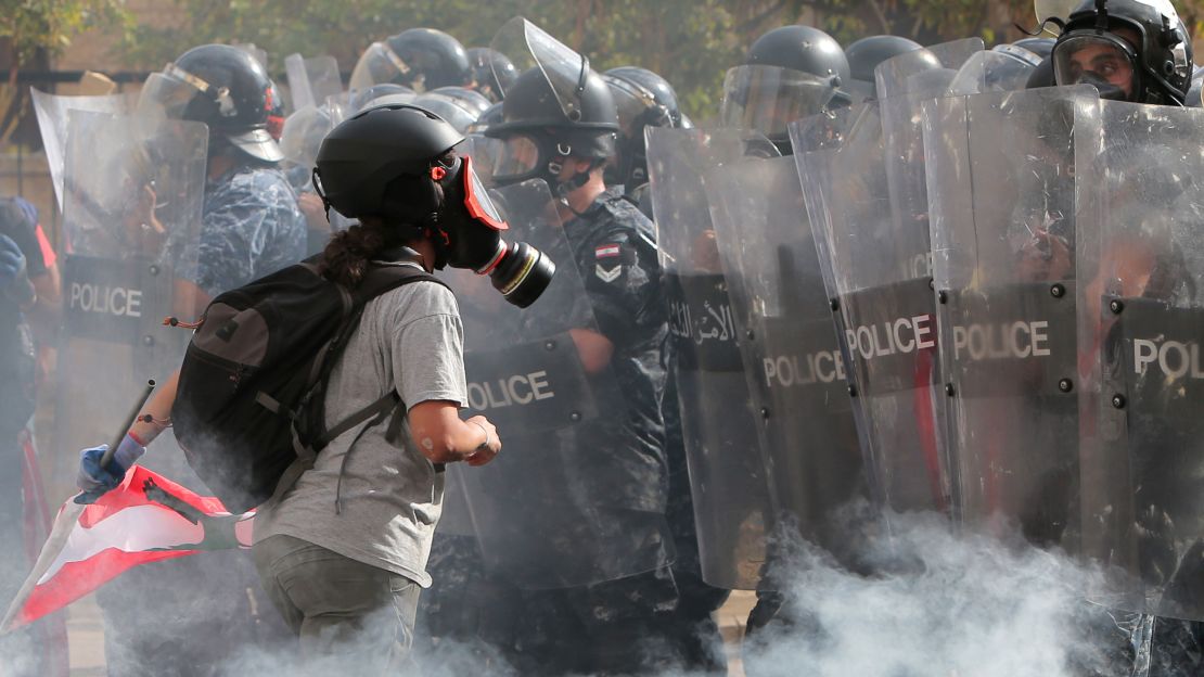 A Lebanese protester speaks with security forces in downtown Beirut on August 8, 2020.