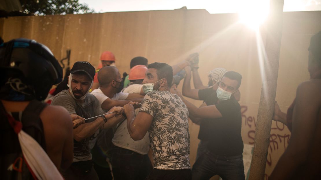 Protesters try to pull down a wall to get inside Parliament.