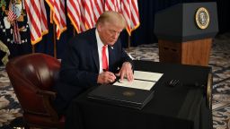 US President Donald Trump signs executive orders extending coronavirus economic relief, during a news conference in Bedminster, New Jersey, on August 8, 2020. 