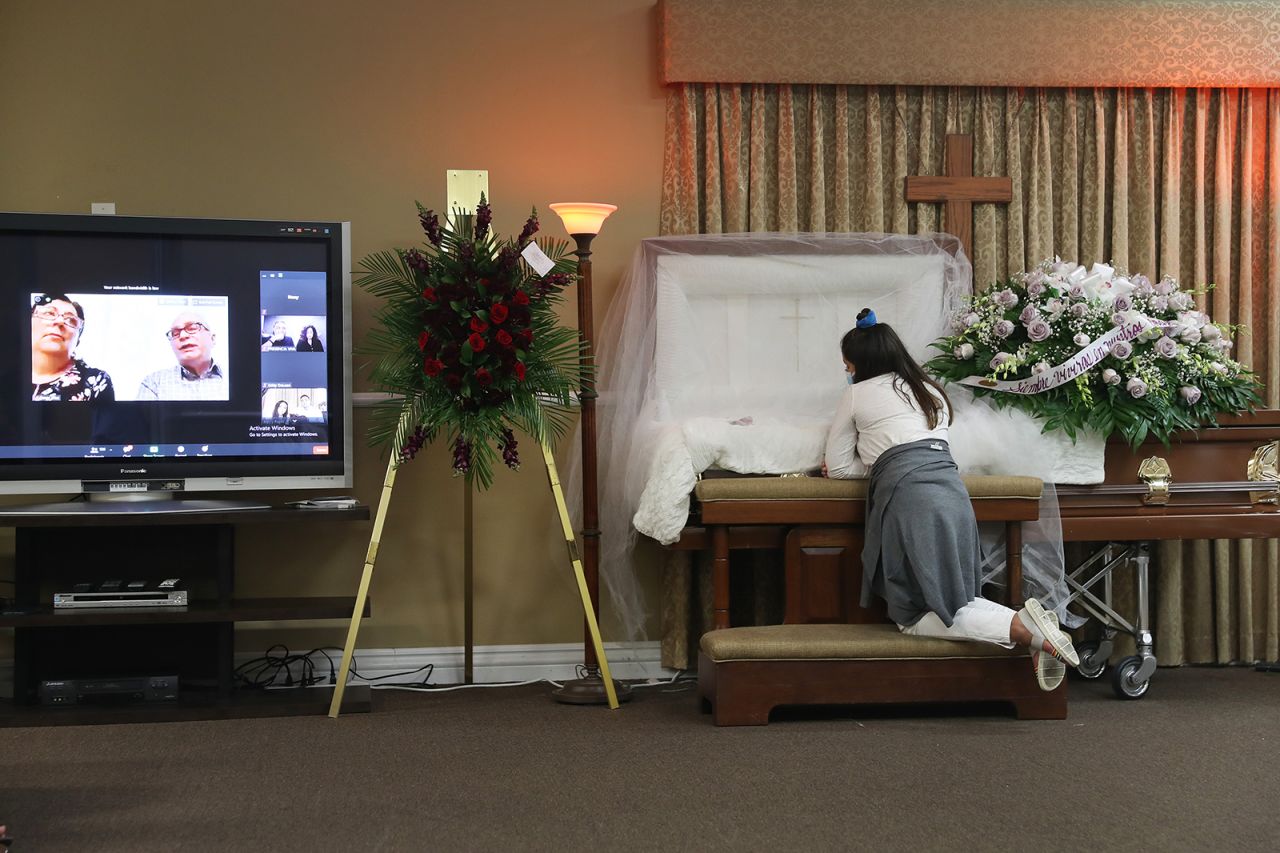 Asare Amaya, 10, mourns her father, German, as family and friends watch his wake via video August 8 in Miami. German Amaya, 55, died from Covid-19.