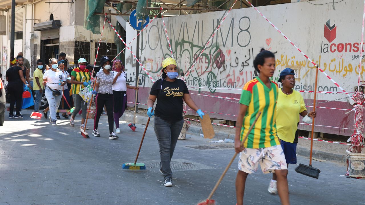 Ethiopian men and women head to Beirut's downtown to help clear up the city's streets.