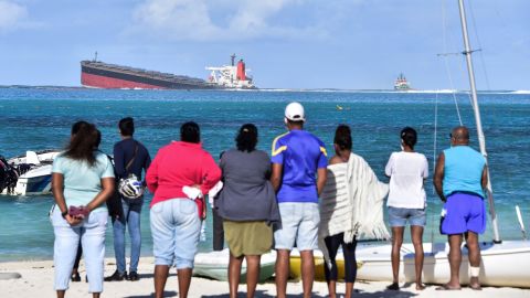 Bystanders look at MV Wakashio near Blue Bay Marine Park in Mauritius.