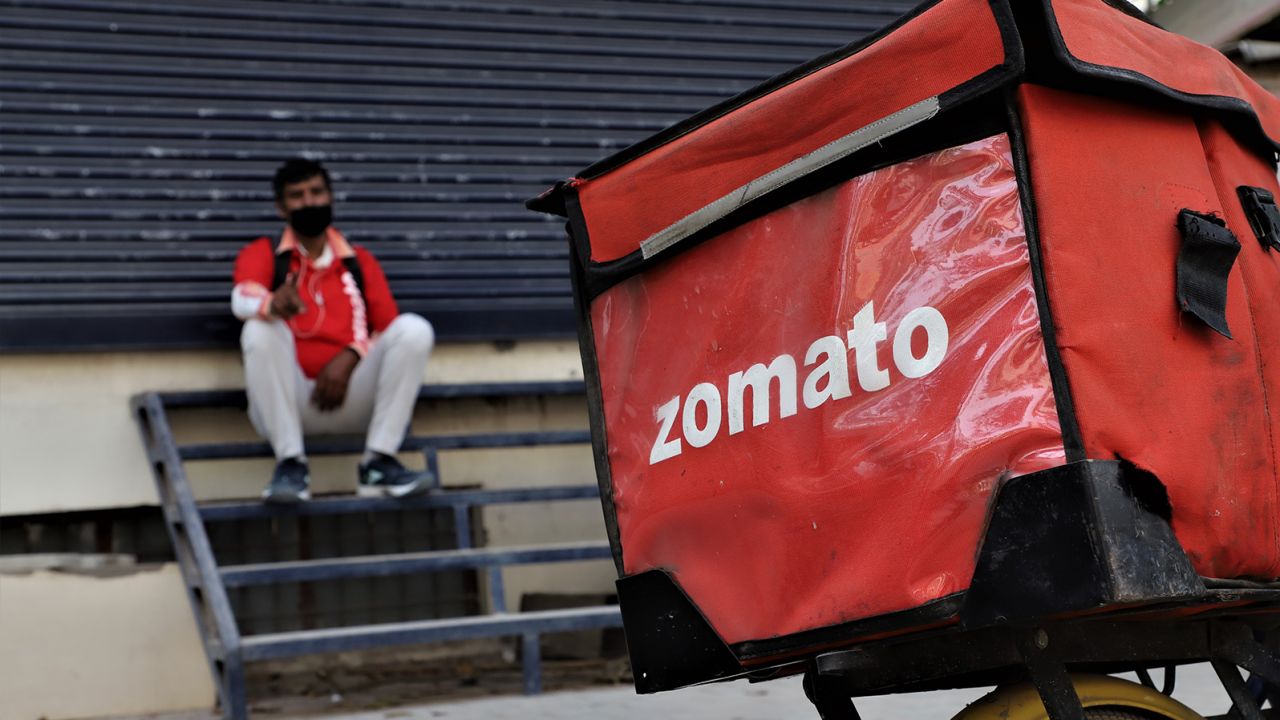 A Zomato food delivery boy takes rest near a closed shop on the outskirts of New Delhi, India on 26 April 2020. 