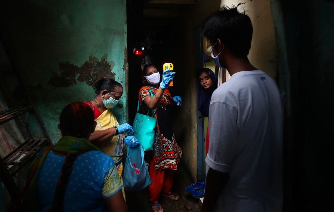 A health worker screens people for Covid-19 symptoms at Dharavi, one of Asia's biggest slums, in Mumbai, India. 